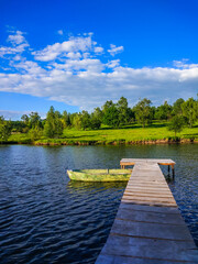 Obraz premium Background of nature landscape with clouds and lake with boat