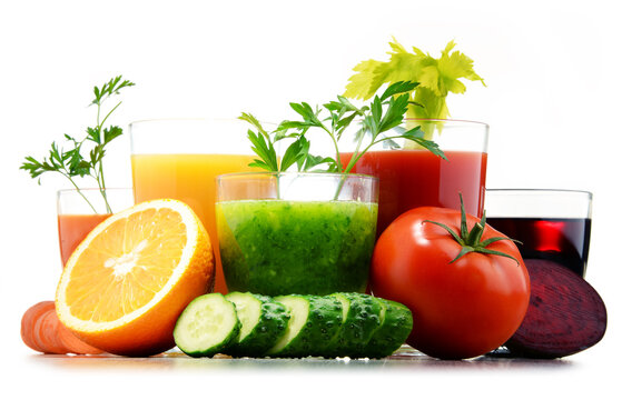 Glasses with fresh organic vegetable and fruit juices on white