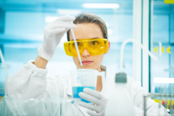 Donna scienziata in laboratorio con strumenti, analisi chimiche o cellule