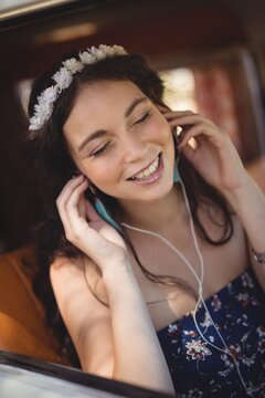 Close up of young woman listening music