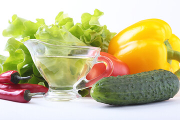 Assorted vegetables, fresh bell pepper, tomato, chilli pepper, cucumber, olive oil and lettuce isolated on white background. Selective focus.