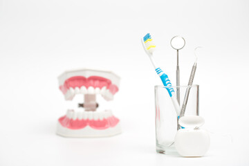 dental tool and dental floss on white background