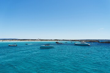 Luxury yachts in turquoise beach of Formentera Illetes