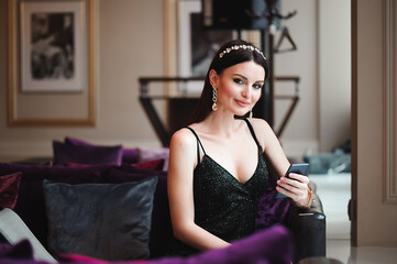 Fototapeta premium Beautiful girl with a phone in the hotel