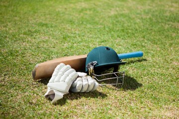 Obraz premium High angle view of cricket equipment on field