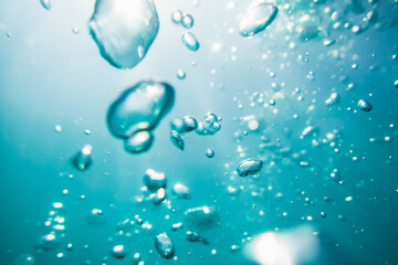 Bubbles and light in ocean. Water texture in underwater