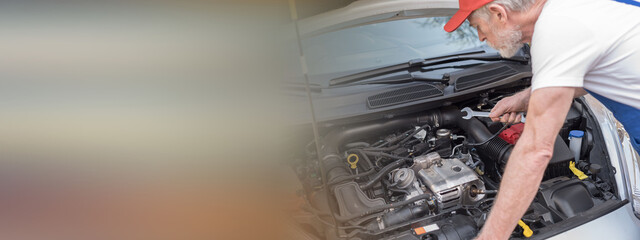 Car mechanic working on car engine