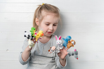 girl with doll puppets on her hands