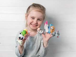 girl with doll puppets on her hands