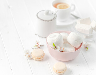 bowl with zefir, white cup of tea