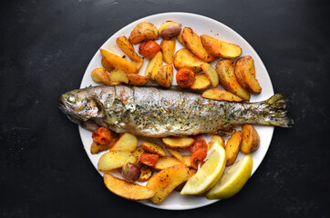 Roasted trout with potatoes in herbs