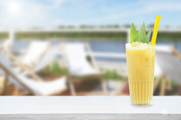 Banana drink on wooden table by river.