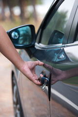 Hand on handle. Close-up of man hand opening a car door.