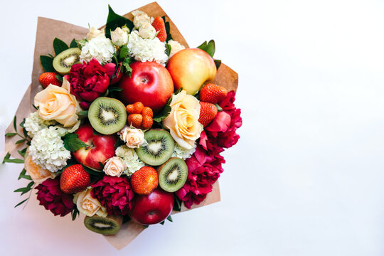 The original edible bouquet of marshmallow, apples, strawberries and flowers on white