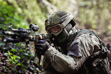 Military man aiming in forest