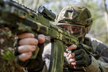 Fototapeta premium Soldier with submachine gun, close-up