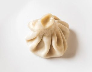 Dumplings Khinkali, manti, pozi, buuzi, poses, xiaolongbao with meat on white plate. Balkan, Caucasian, Asian cuisine.