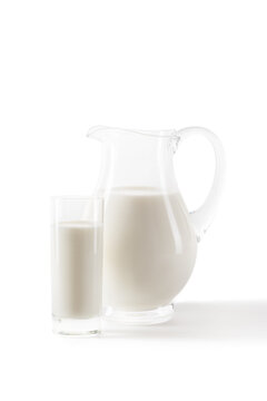 fresh milk in jug and glass for healthy breakfast isolated on white