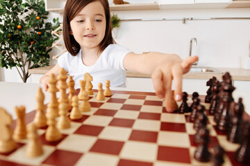 Prodigy girl moving a white pawn