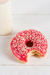 sweet doughnut and fresh milk in glass bottle on tabletop