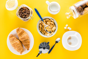 Top view of tasty breakfast with cereal flakes and croissants with coffee