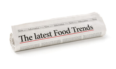Rolled newspaper with the headline The latest Food Trends - obrazy, fototapety, plakaty