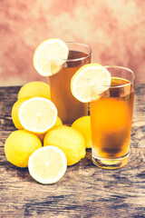 lemon ice tea on wooden table with lemons around