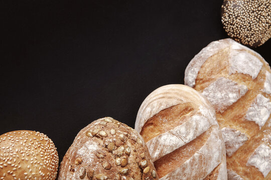 Bakery concept. Plenty of bread background isolated on balck