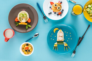 flat lay with creatively styled children's breakfast with drinks on plates