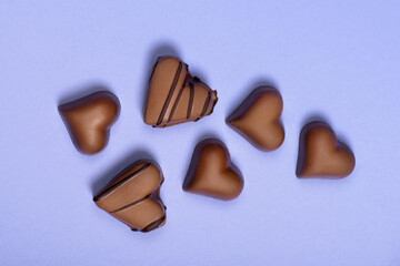 top view of chocolate heart shaped candies isolated on blue