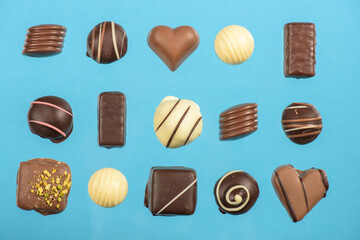 flat lay with various chocolate candies isolated on blue