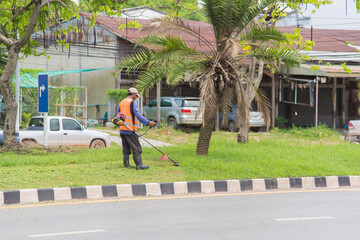 Road sweeper worker cleaning city street with broom tool in Thailand