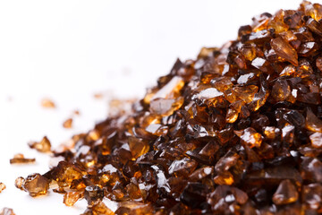 Heap of brown Amber stones on white background