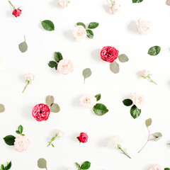 Floral pattern made of red and beige roses, green leaves, branches on white background. Flat lay, top view. Valentine's background. Pattern of flowers. Texture