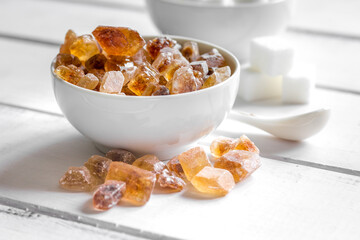 white and brown sugar for cooking sweets on kitchen white wooden table close up