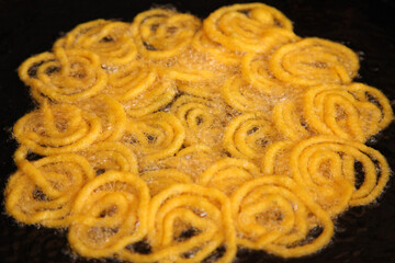 Delicious jalebi frying in oil pan