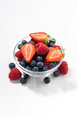 fresh seasonal berries in a glass bowl, vertical