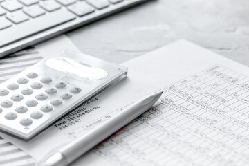 Obraz premium accounting work space with calculator, profit and tables on stone desk close up