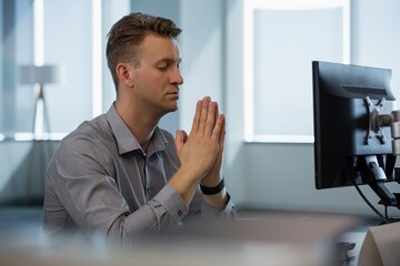 Executive meditating at desk