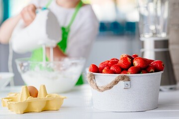 Cake ingredients on white table in kitchen