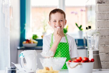 Obraz na płótnie Canvas Child preparing sweet dessert and snacking