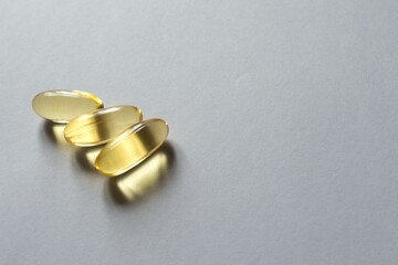 Three softgels of evening primrose oil supplement (left)