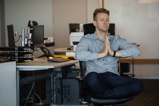 Executive meditating at desk