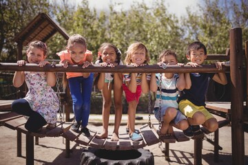 Portrait of happy schoolkids playing in playground