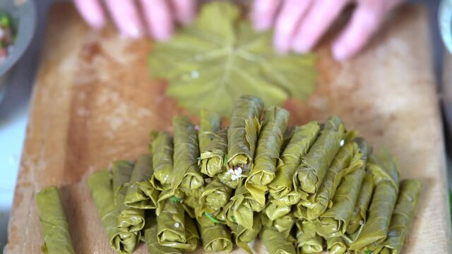 Making dolma, yaprak sarma, stuffed grape leaves, traditional turkish cuisine.