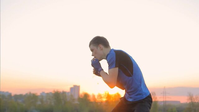 young man Boxing with shadow in the Park