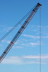 Crane arm on blue sky background