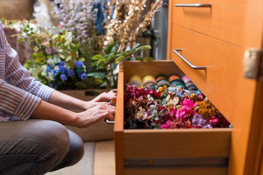 Woman in craft shop choosing flowers