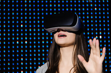 Young woman experiencing virtual reality glasses
