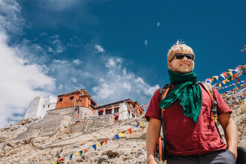 Happy smiling tourist man under deep blue tibetan sky